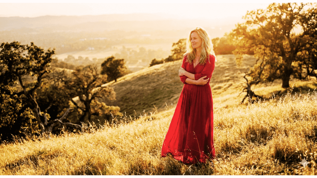 Blonde woman in red reflecting on her journey to Finally Me, practicing self-love and presence